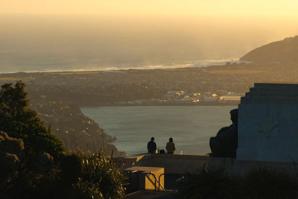 A couple at Signal Hill Lookout admire a view of the city.
