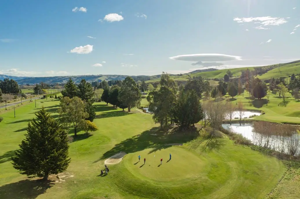 An aerial shot of a group of golfers on Taieri Lakes Golf Course.