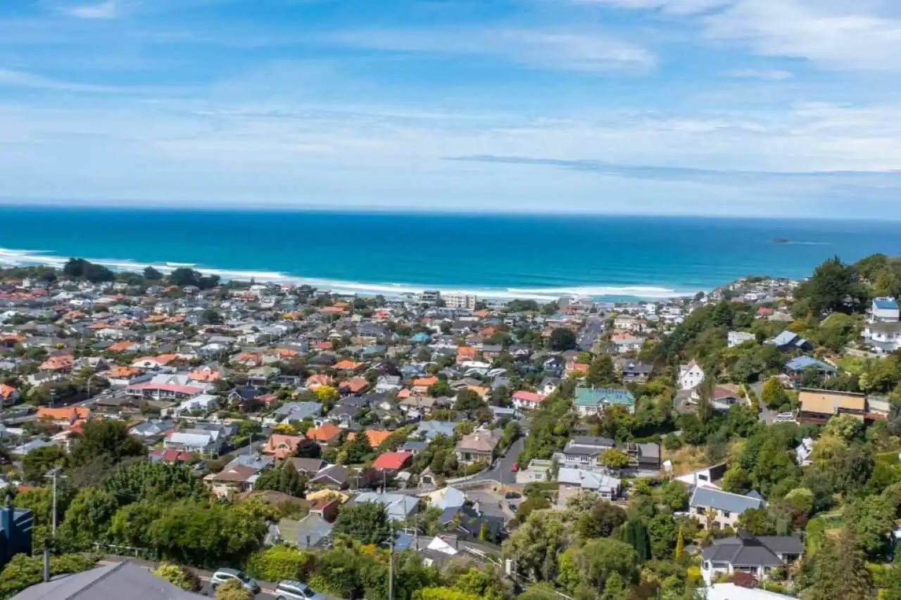 Aerial photo o St Clair and South Dunedin with view out to blue ocean.