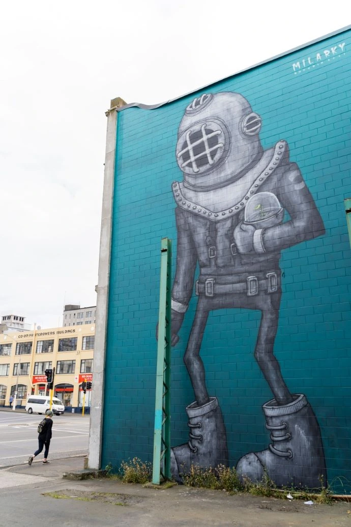 Street Art Trail Aquanaut A large mural depicts a blue Aquanaut holding a plant.