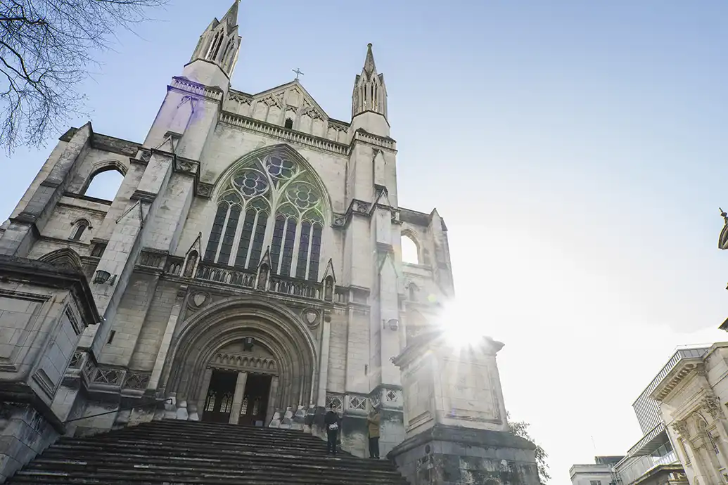 St Pauls Cathedral St Pauls Cathedral from the bottom of the front steps looking up to the church with the sun peaking from behind