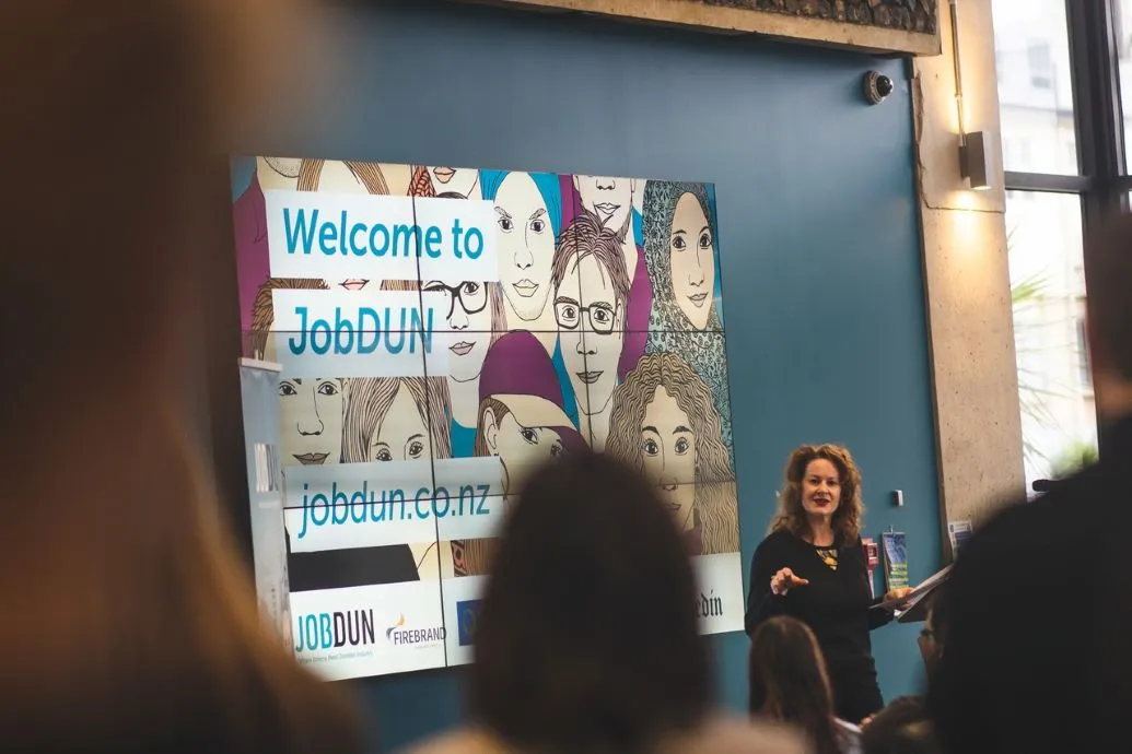 A presentation on JobDUN is given to a seated audience.