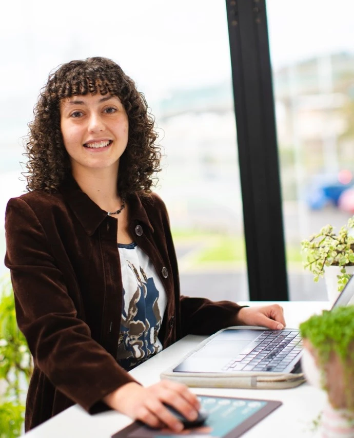 A woman from Dunedin agency Platinum Recruitment smiles from her desk.
